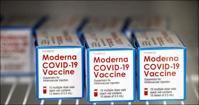 Boxes containing vials of the Moderna COVID-19 vaccine sit in a refrigerator at Augusta University in Augusta, Ga.