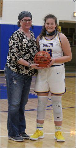 After scoring her 1,000th career point, Union junior Dominika Logue was presented the game ball by Union alumna and previous 1,000 point scorer, Tracie Murray Bowser.