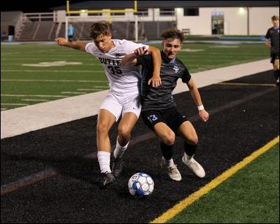 Seneca Valley's Maxwell Marcotte fights for a loose ball against Butler's Nick Kilgore in the Raiders' 2-1 home win Thursday.