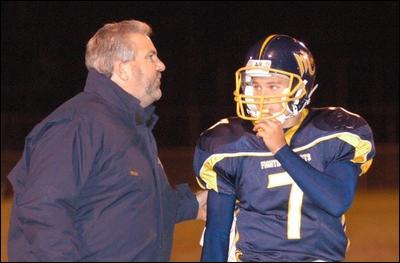 Mars quarterback Zach Rosswog talks things over with Planet football coach Scott Heinauer during a 2002 game. Rosswog, who graduated as the school's all-time passing leader, was inducted into the Mars Athletic Hall of Fame last month.