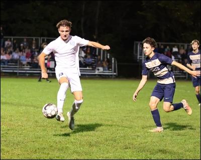 Seneca Valley's Maxwell Marcotte (13) traps a ball ahead of Butler's Gavin Varner during the undefeated Raiders' 1-0 boys soccer victory Wednesday night.