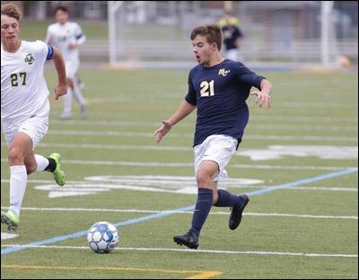 Mars midfielder Devin Schupp (21) moves the ball upfield against Belle Vernon in WPIAL Class 3A boys soccer playoff action Saturday at the Mars Athletic Complex. Schupp scored three goals in the Planets' 4-0 victory.