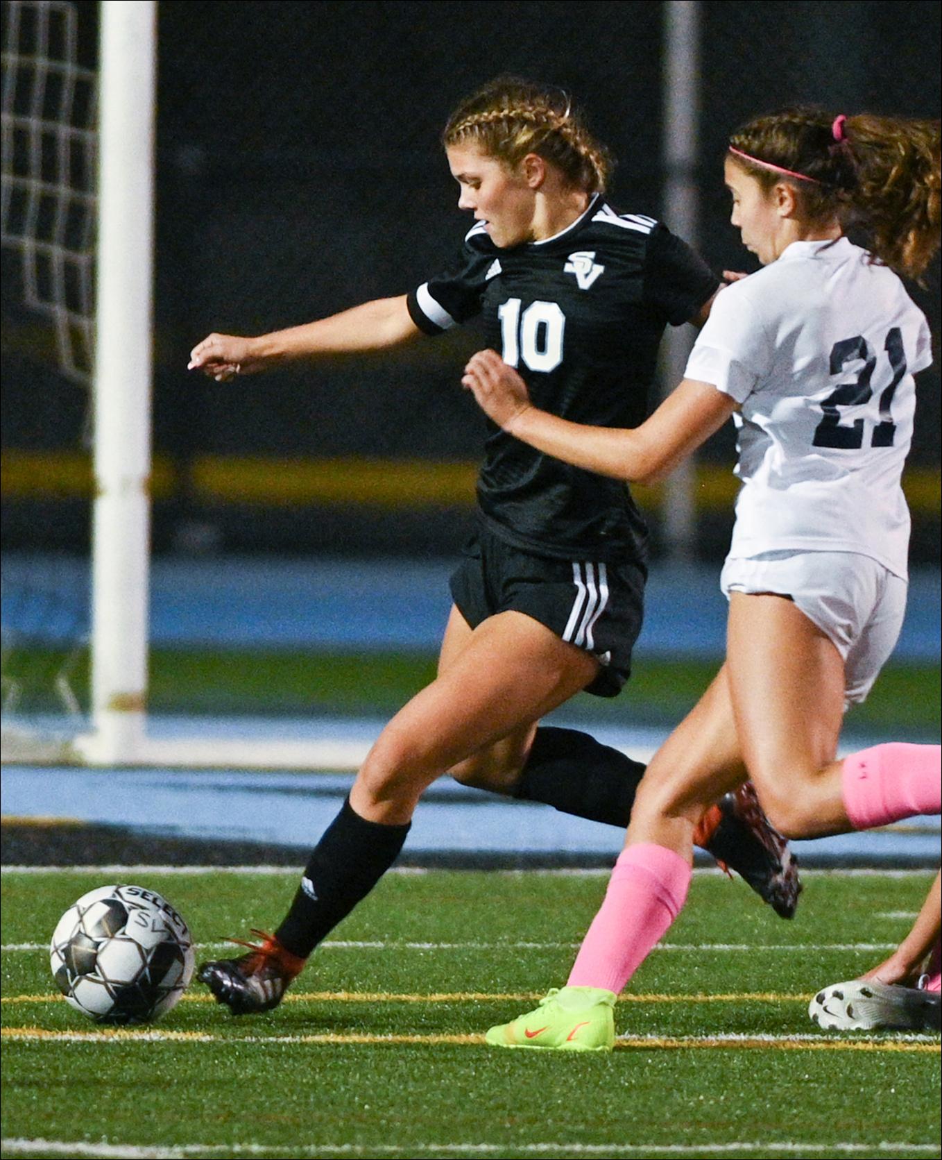 Seneca Valley's Olivia Kamarec (10) looks to clear the ball against Norwin's Evelyn Moore (21) at Seneca Valley's NexTier Stadium Thursday.