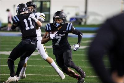 Seneca Valley ball carrier (7) Brandon Ross evades a North Allegheny tackler at Seneca Valley High School on September 24, 2021.
